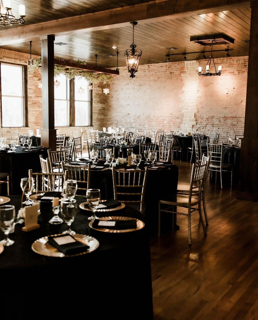 Long banquet table set with gold linens and floral centerpieces in the Main Hall