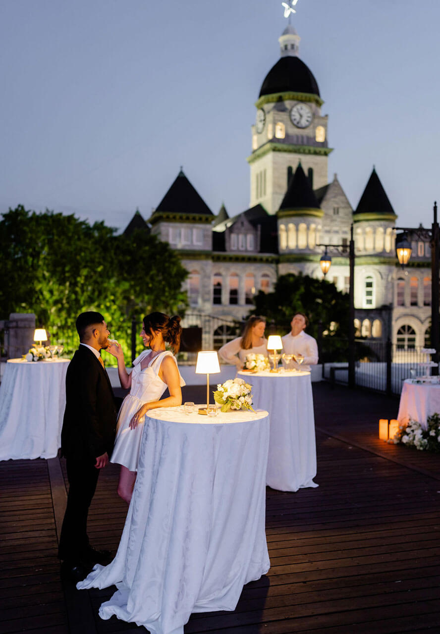 Couple at a candlelit table on the rooftop after dark