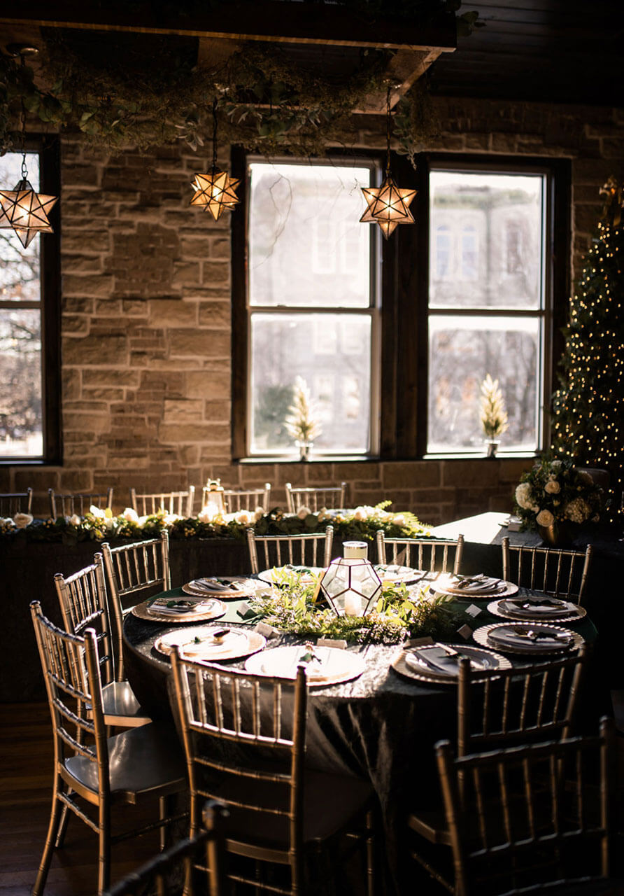 Intimate candlelit dinner setting with star lanterns and greenery